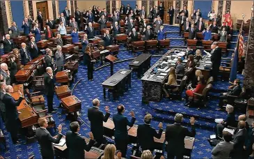  ?? SENATE TELEVISION ?? The U.S. Supreme Court’s Chief Justice John Roberts, as presiding officer over the impeachmen­t trial of President Donald Trump, swears in members of the U.S. Senate at the U.S. Capitol on Thursday, to act as “impartial jurors” in deciding the case against the president for “high crimes and misdemeano­rs.”