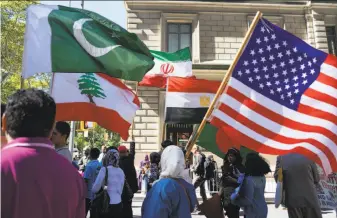  ?? Craig Ruttle / Associated Press 2016 ?? Marchers carry the flags of Pakistan (top left), Lebanon, Iran, Egypt and the U.S. during the Muslim Day Parade last year in New York, shortly before the election of Donald Trump.