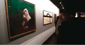  ??  ?? Visitors stand next to paintings (left to right) by Irish-born British painter Francis Bacon “Reclining Man with Sculpture” and American artist Franz Kline “untitled” during the opening ceremony of an exhibition of modern art at Tehran’s Museum of...