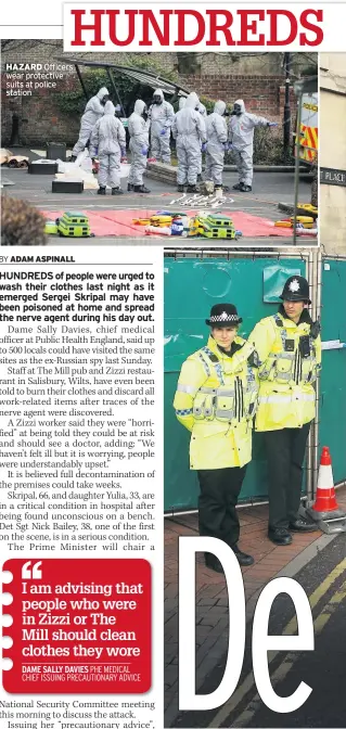  ??  ?? HAZARD Officers wear protective suits at police station