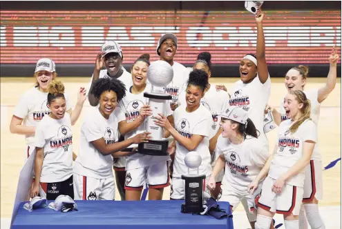  ?? Jessica Hill / Associated Press ?? The UConn women’s basketball team celebrates its win over Marquette in the Big East Tournament championsh­ip on Monday at Mohegan Sun Arena in Uncasville.