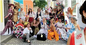  ?? ?? Sade (seated third from right in orange) with fellow contestant­s in national dress