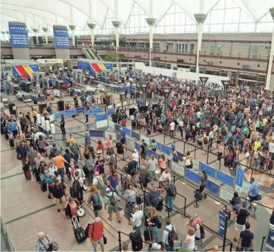 ?? TREVOR HUGHES/USA TODAY ?? Hundreds of travelers wait in TSA security lines in Denver Internatio­nal Airport’s Great Hall. Airport managers have launched a major renovation of the hall, hoping to speed security screenings and improve the passenger experience.
