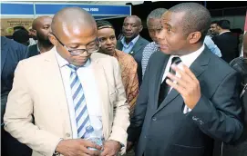  ??  ?? Grain Millers’ Associatio­n of Zimbabwe chairman Mr Tafadzwa Musarara stresses a point to the Minister of Industry and Commerce, Nqobizitha Mangaliso Ndlovu, during a tour of millers’ stands at a function in Bulawayo last week