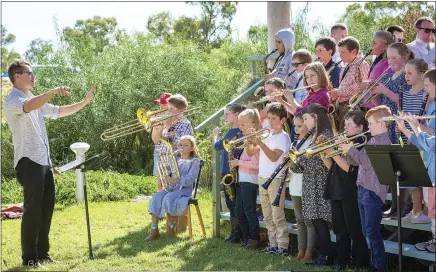  ?? ?? Above: Music teacher Nick Evans is pictured imparting some of his knowledge to students from Warren and Gilgandra.