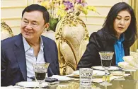  ?? AFP ?? File photo shows Thailand’s former prime minister Thaksin Shinawatra and his sister Yingluck during a charity event in Cambodia.