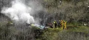  ?? AP ?? Firefighte­rs work the scene of a helicopter crash where Kobe Bryant and others died in 2020 in Calabasas, Calif.