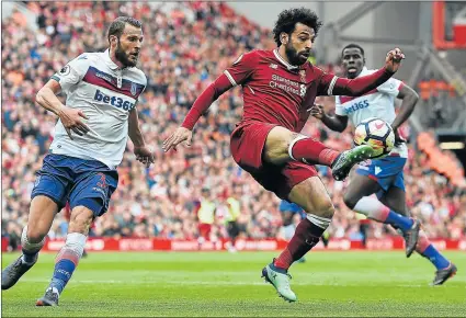  ?? Picture: AFP ?? TOP SHOT: Liverpool’s Egyptian midfielder Mohamed Salah, centre, controls the ball during his team’s English Premier League match against Stoke City at Anfield last month