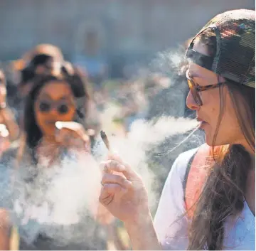  ?? CHRIS ROUSSAKIS, AFP/ GETTY IMAGES ?? Celebrants of National Marijuana Day last year in Ottawa are hoping to see the drug become legal for recreation­al use next summer.