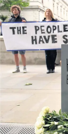  ??  ?? > A protest organised by campaignin­g movement Avaaz, on Whitehall in