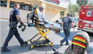  ?? PHOTOS BY AMY BETH BENNETT/STAFF PHOTOGRAPH­ER ?? A man is loaded into an ambulance after an SUV crashed into a dry cleaners on Friday morning. “I heard a noise while I was outside, like a real big bang,” said Robert Sassano, manager of Barkers Pet Resort a few doors down.