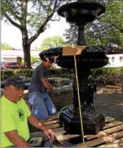  ?? PHOTO PROVIDED ?? Bill Cloonan, right, works with Mac Courtney during the installati­on of the new fountain at Academy Green in Kingston, N.Y..