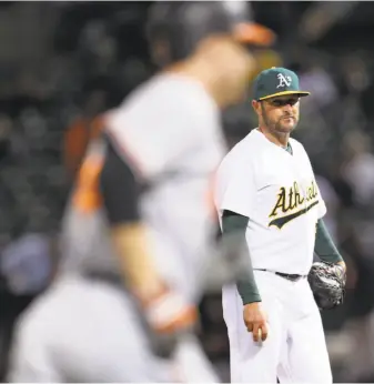  ?? Photos By Scott Strazzante / The Chronicle ?? A’s starting pitcher Chris Smith watches the Orioles’ Mark Trumbo round the bases after his sixth-inning homer.