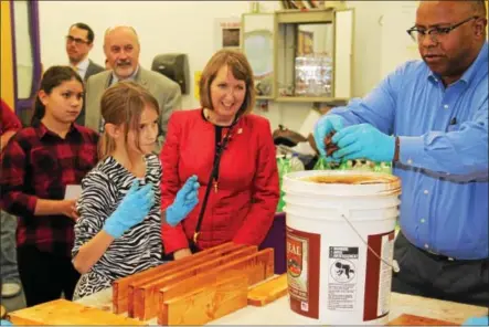  ?? PHOTOS PROVIDED ?? Teacher Christophe­r Meyers, right, and student Ivy Riley, second from left, show Rensselaer County Executive Kathleen Jimino and Troy Mayor Mayor Madden a project they’re working on in a woodworkin­g class during a Lights On After School program...