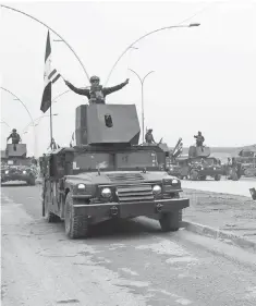  ?? KHALID MOHAMMED, AP ?? Iraq’s special forces troops parade to celebrate the liberation of the eastern side of Mosul, Iraq.