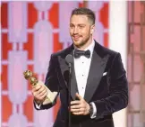  ??  ?? Aaron Taylor-Johnson with his award for best supporting actor in a motion picture for his role in "Nocturnal Animals".