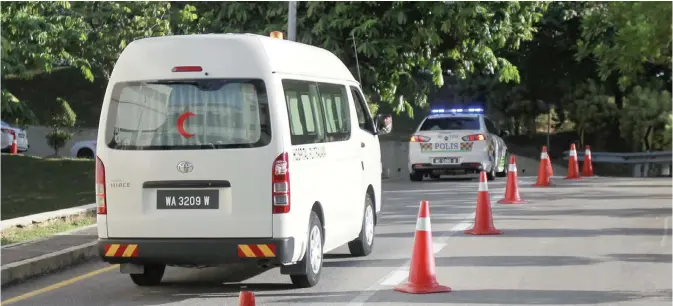  ?? —AP ?? PUTRAJAYA: A hospital van is escorted by a police vehicle as it leaves the hospital forensic department in Putrajaya, Malaysia yesterday. Kim Jong Nam, 46, was targeted Monday, Feb. 14, 2017, in a shopping concourse at Kuala Lumpur Internatio­nal...