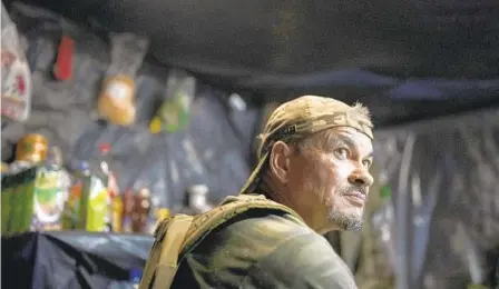  ?? BRAM JANSSEN AP ?? A Ukrainian soldier sits inside a trench on the front line in the outskirts of Lyman, Ukraine, on Tuesday.