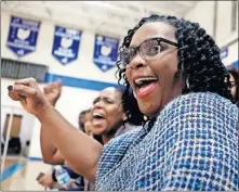  ??  ?? Shirlie Bramwell cheers for her daughter Derricka Bramwell during a Ready basketball game. Shirlie serves as the team scorekeepe­r for road games.