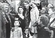  ?? AP ?? George Bailey (Jimmy Stewart), center, holds Zuzu (6-year-old Karolyn Grimes), in the 1946 Frank Capra classic “It’s a Wonderful Life.”