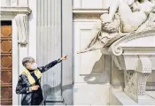  ??  ?? A curator points at the newly cleaned sculpture Night by Michelange­lo in the Medici Chapel, Florence