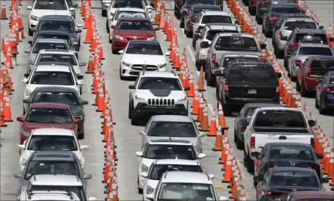  ?? Wilfredo Lee/Associated Press ?? Lines of cars wait at a coronaviru­s testing site outside of Hard Rock Stadium in Miami Gardens, Fla., on Friday.