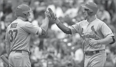  ?? Nam Y. Huh / The Associated Press ?? St. Louis’ Stephen Piscotty (right) celebrates with Brandon Moss after hitting a solo home run against the Chicago Cubs.