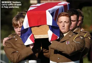  ?? ?? SERVICE Soldiers carry coffin draped in flag yesterday