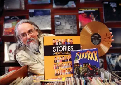  ?? Associated Press ?? Chris Brown poses with an orange vinyl recording of Stories for Ways and Means and Slick Rick's “The Great Adventures of Slick Rick,” a 7-inch single packaged in a board book, at Bull Moose Music in Portland, Maine. Brown, a Bull Moose employee,...