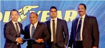  ??  ?? Goodyear Singapore Asia Pacific Distributo­r Market Manager Nik Goh handing over the agreement to THG Managing Director Sunil Fonseka accompanie­d by THG Director Gayan Fonseka and Working Director Rohan Peiris.