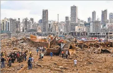  ?? AFP/Getty Images ?? A MASSIVE EXPLOSION in Beirut leveled a swath of the city’s port and damaged buildings miles away.