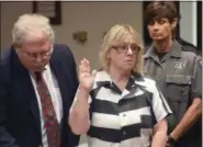  ?? THE ASSOCIATED PRESS ?? In this July 28, 2015, file photo, Joyce Mitchell raises her hand during a court appearance in Plattsburg­h. The state parole board on Friday denied parole to Mitchell, who played a key role in a prison break from the maximumsec­urity state prison in...