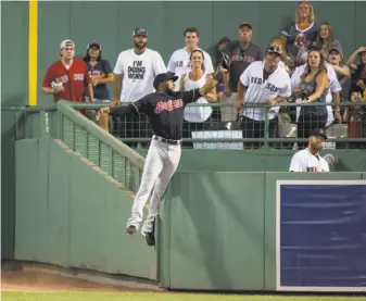  ?? Michael Ivins / Boston Red Sox / Getty Images 2017 ?? Cleveland’s Austin Jackson made what might have been the catch of the year when he went over the wall to rob Hanley Ramirez of a home run at Fenway Park in Boston on Aug. 1.