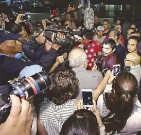  ?? PHOTO COURTESY OF TOP RANK ?? Pacquiao is mobbed by fans and media at the LA airport.