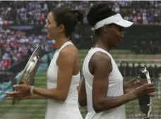  ?? TIM IRELAND/THE ASSOCIATED PRESS ?? Wimbledon champion Garbine Muguruza and runner-up Venus Williams strike the pose after Saturday’s one-sided final at the All England Club.