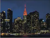  ?? FRANK FRANKLIN II — THE ASSOCIATED PRESS ?? The Empire State Building is lit in red Tuesday as part of a national memorial to lives lost to COVID-19.