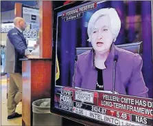  ?? [RICHARD DREW/THE ASSOCIATED PRESS] ?? The Washington news conference of Federal Reserve Chair Janet Yellen is shown on a television on the floor of the New York Stock Exchange. Fed policymake­rs have raised their benchmark rate to a range of 1 percent to 1.25 percent and indicated that they...