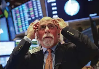  ?? DREW ANGERER/GETTY IMAGES ?? A trader works on the floor of the New York Stock Exchange on Thursday as the session nears its end. The S&amp;P 500 has declined for each of the last six trading days.