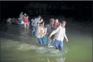  ?? DARIO LOPEZ-MILLS / AP ?? Migrant families, mostly from Central American countries, wade through shallow waters in Roma, Texas, this week.