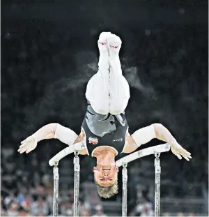  ??  ?? On a high: Nile Wilson came first in the parallel bars on his way to taking the all-around title