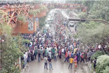  ?? — Reuters ?? Students block a road during a protest in Dhaka on Sunday.