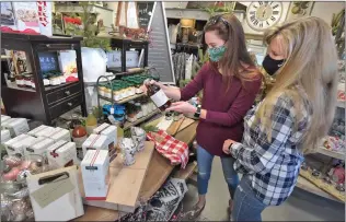  ?? Dan Watson/ The Signal ?? Caroline, left, and Chell Amsler examine a new line of select jams, spreads and mustards from Stonewall Kitchen available at Refined Vintage Boutique in Valencia on Wednesday.