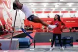  ?? The Associated Press ?? ■ Rutgers women’s gymnastics coach Umme Salim-Beasley watches as student athletes practice at Rutgers on March 2 in Piscataway, N.J.