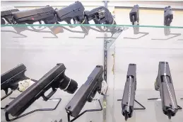  ?? ALAN DIAZ/ASSOCIATED PRESS ?? This 2016 photo shows guns on display at a gun store in Miami. Gun violence in the weeks after a Florida school shooting that left 17 dead has sparked nationwide protests.