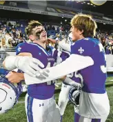  ?? PAUL W. GILLESPIE/CAPITAL GAZETTE ?? St. Mary’s Kevin Berzins, left, and Aiden Pongratz celebrate as the final seconds come off the clock in a 21-13 win over Concordia Prep in the MIAA B Conference championsh­ip game Friday night at Navy-Marine Corps Memorial Stadium.