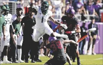  ?? TONY GUTIERREZ/AP ?? BAYLOR RUNNING BACK TRESTAN EBNER (1) leaps over TCU placekicke­r Griffin Kell (39) while returning a punt in the first half of a game in Fort Worth, Texas, Saturday.