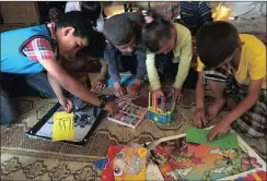  ?? Picture: NADIA MEER ?? ART THERAPY: From left, Muhammad Nawajah, Layth Nasr, Zahra Mahmoud, and Ahmad Nawajah create their artworks for the calendar in a tent school in the South Hebron Hills. Their real school was demolished during forced removals.