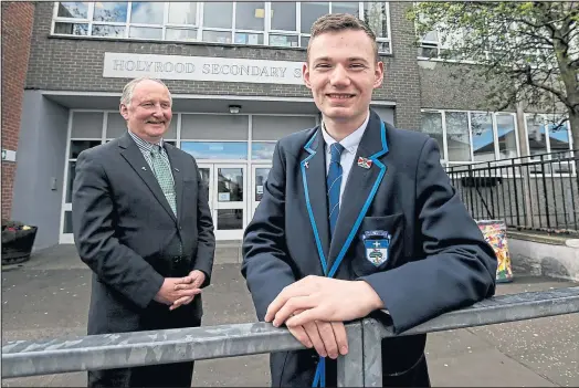  ??  ?? Holyrood Secondary School pupil Ryan Thorne with head teacher Laurie Byrne Picture: Colin Mearns