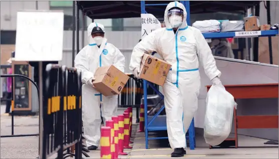  ?? WU YIBIN / FOR CHINA DAILY ?? Community workers in protective suits deliver parcels of daily necessitie­s for residents quarantine­d at home in Shunyi district, Beijing, on May 10.