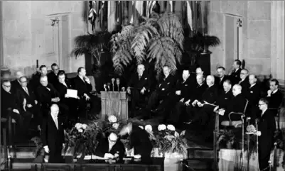  ?? Associated Press ?? Belgium’s Premier and Foreign Minister Paul-Henri Spaak, seated center, tests a new pen before signing the North Atlantic Pact in Washington on April 4, 1949. NATO celebrated 75 years of collective defense across Europe and North America as Russia’s war on Ukraine enters its third year.